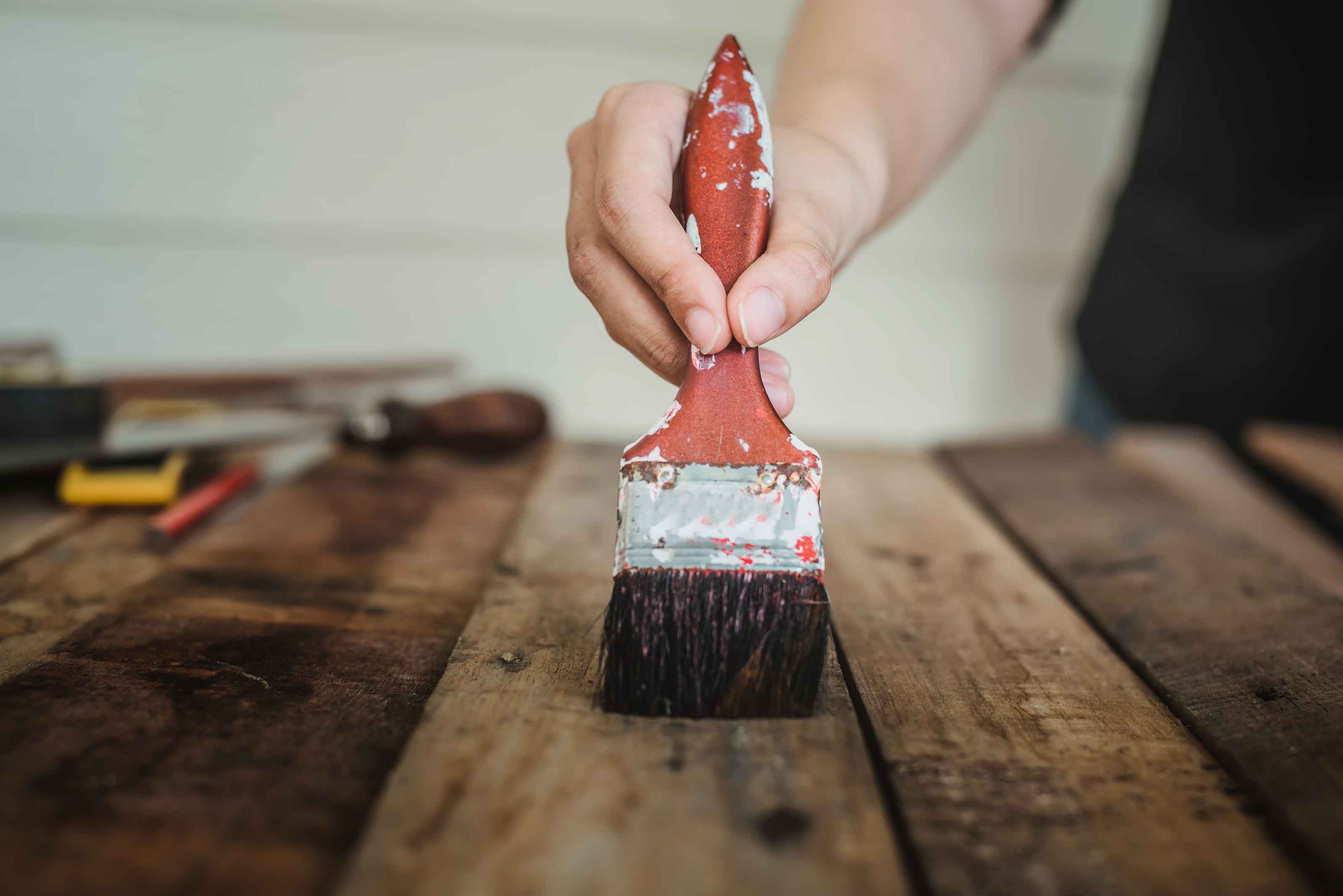 painting garden sleepers in protective wood oil