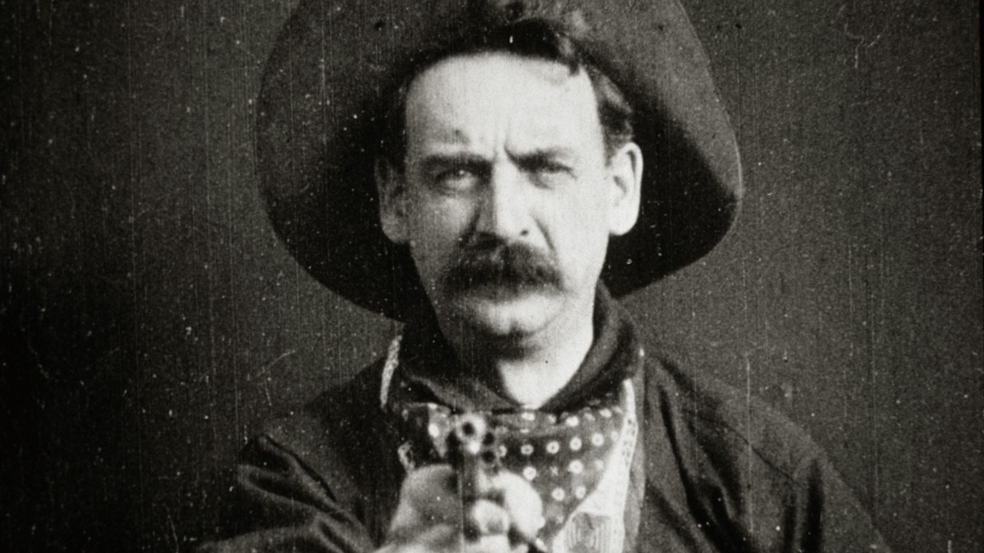 Cowboy pointing gun at camera