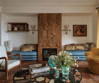 living area with wooden floorboards and inbuilt blue velvet seating and terrazzo marble coffee table