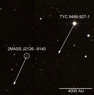 False color infrared image of the star TYC 9486-927-1 and the planet 2MASS J2126; arrows show their projected movement over 1,000 years. The scale indicates a distance of 4,000 astronomical units (AU), where 1 AU is the average distance between the Earth and the sun (about 93 million miles, or 150 million kilometers).