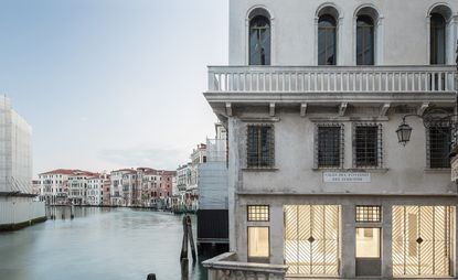OMA’s Fondaco dei Tedeschi restoration building next to Venice river