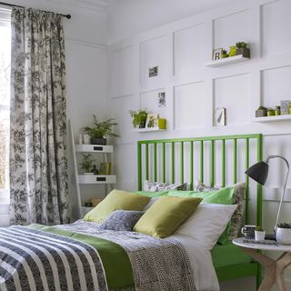 bedroom with printed curtains and panelled walls