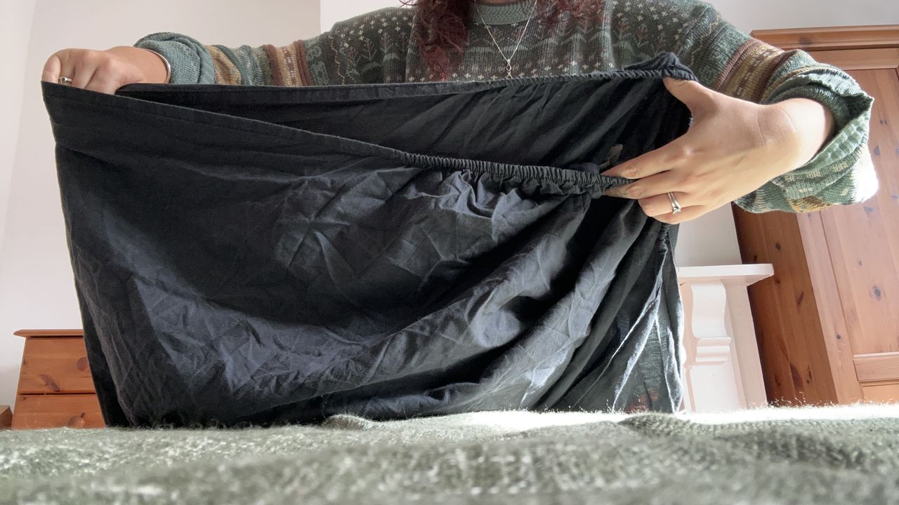 The Tom's Guide Sleep Features Editor folding the corners of a fitted sheet