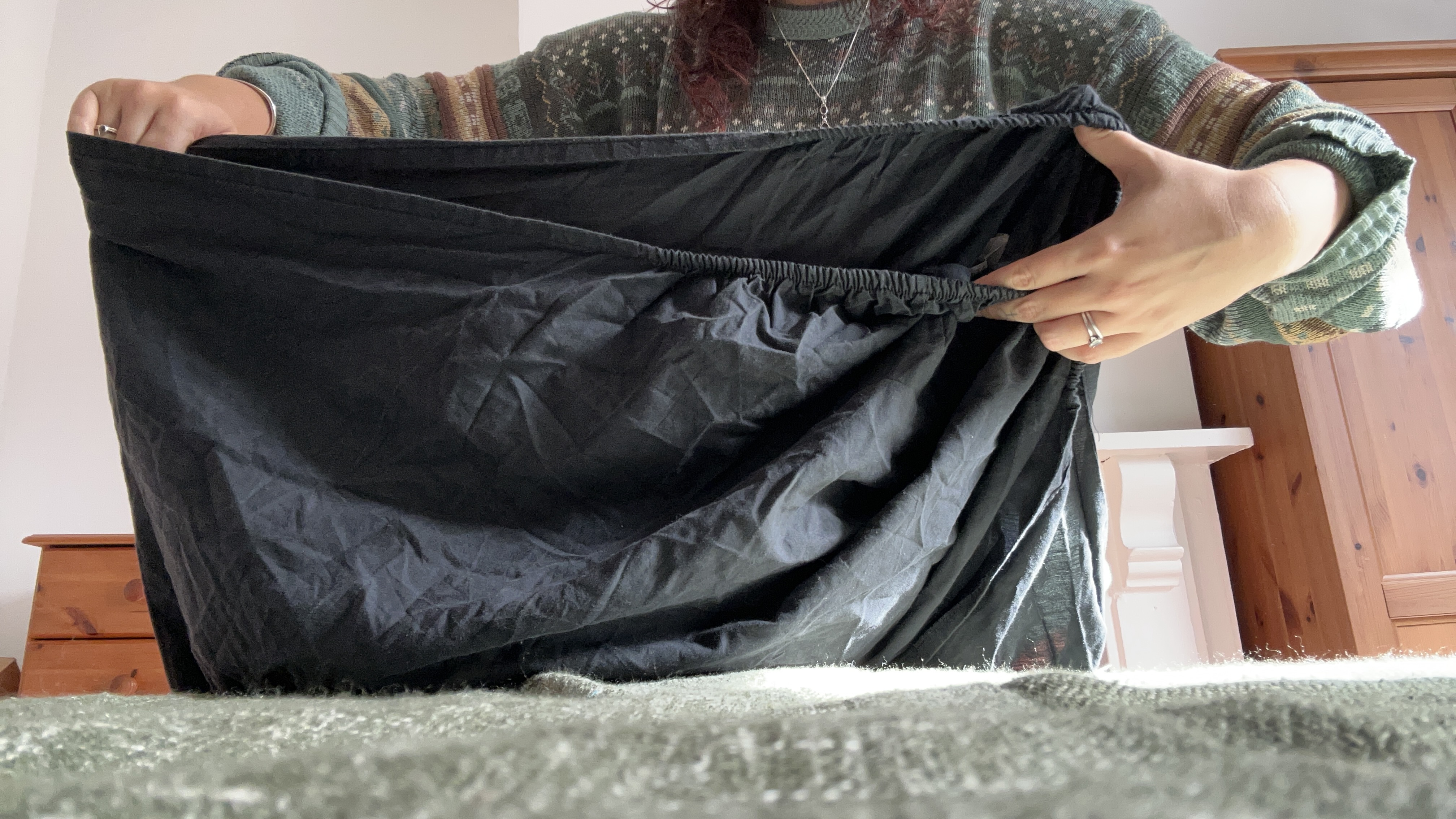 The Tom's Guide Sleep Features Editor folding the corners of a fitted sheet