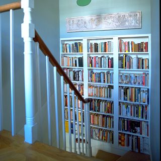 bookcase with shelving and stairs