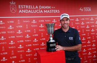 Julien Guerrier smiles next to the 2024 Andalucia Masters trophy