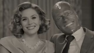 Elizabeth Olsen and Paul Bettany smiling on a couch in WandaVision