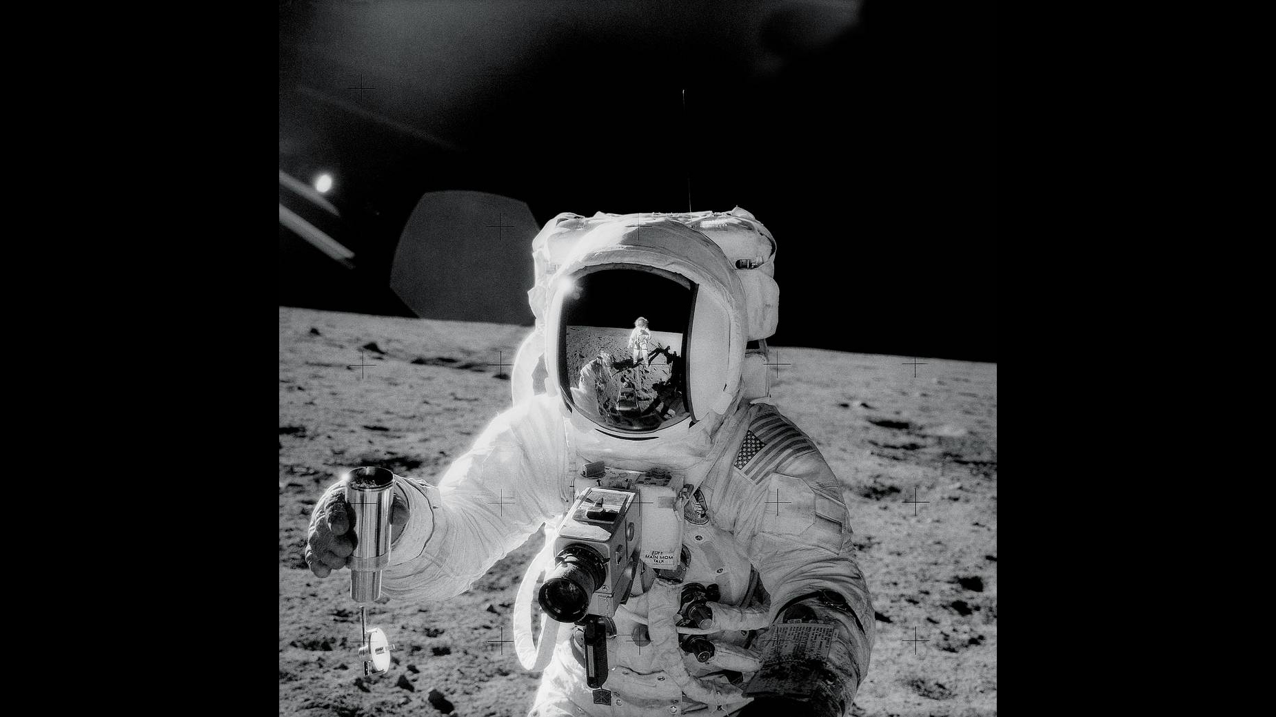 Apollo 12 Launches for Second Moon Landing — Nov. 14, 1969, Astronaut Alan L. Bean holds a Special Environmental Sample Container filled with lunar soil collected during an extravehicular activity. Apollo 12 Commander Charles Conrad Jr., who is reflected in Bean’s helmet visor, accompanied him on the EVA