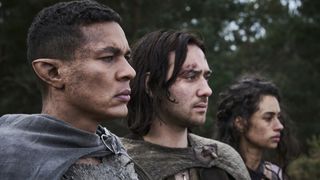 Arondir, Isildur, and Estrid look at something off screen in The Rings of Power season 2