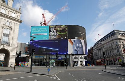 The electronic billboard displays an advert thanking Britain's emergency services for their dedication during the COVID-19 pandemic, in an empty in Piccadilly Circu in London on April 2, 2020