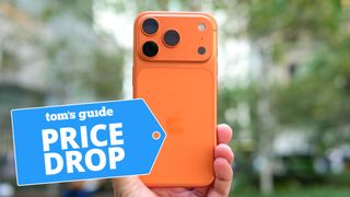 Orange iPhone 17 Pro held in hand