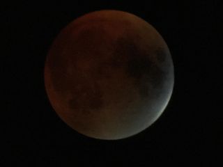 Veteran night sky photographers Imelda Joson and Edwin Aquirre used a spotting scope and smartphone to capture this view of the total lunar eclipse of Sept. 27, 2015 as seen from the Burlington area of Massachusetts.