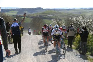 SIENA ITALY MARCH 06 Tadej Pogacar of Slovenia and UAE Team Emirates Julian Alaphilippe of France and Team Deceuninck QuickStep Mathieu Van Der Poel of Netherlands and Team AlpecinFenix during the Eroica 15th Strade Bianche 2021 Mens Elite a 184km race from Siena to Siena Piazza del Campo Breakaway Gravel Strokes Dust StradeBianche on March 06 2021 in Siena Italy Photo by Tim de WaeleGetty Images