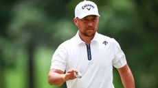 Xander Schauffele reacts after making a par on the second hole during the second round of the Wells Fargo Championship at Quail Hollow Country Club on May 10, 2024