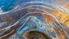 Aerial view of excavators and transport vehicles busy with work at Dexing Copper Mine on August 16, 2024 in Shangrao, Jiangxi Province of China.