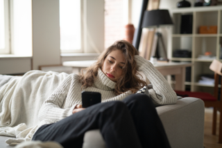 woman sitting at home alone during national lockdown