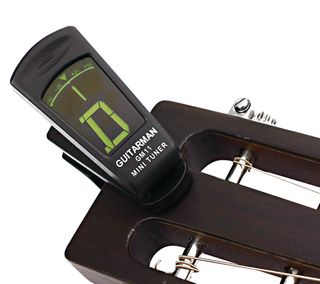 Electronic clip-on tuner on guitar headstock