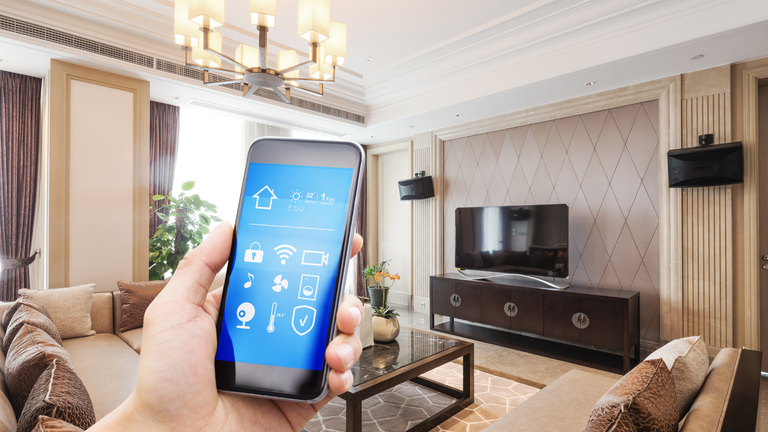 The best smart light swtiches: Image depicts living room with phone app to control devices