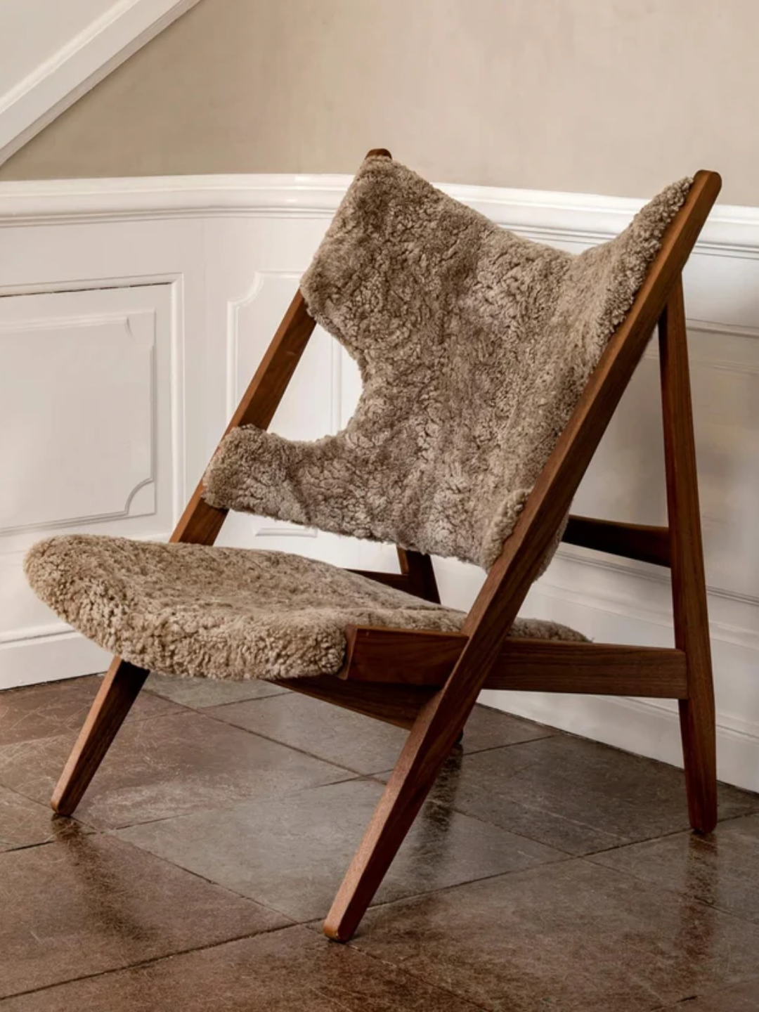 A lounge brown sheepskin armchair from Audo Copenhagen