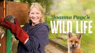 An image of Joanna Page smiling and holding a curled up hedgehog while wearing thick red gloves. There is a green nature background and with an image of a fox and 'Joanna Page's Wild Life' written in the foreground. 