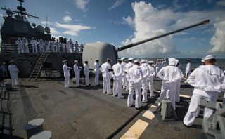 Members of the US Navy are seen during the burial at sea service for Neil Armstrong aboard the USS Philippine Sea (CG 58), Friday, Sept. 12, 2012, in the Atlantic Ocean.