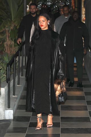 Rihanna is stylish in an all black ensemble as she and partner A$AP Rocky attend a party at Hind in West Hollywood. She wore a black dress and leather duster coat with a black alaia shoulder bag