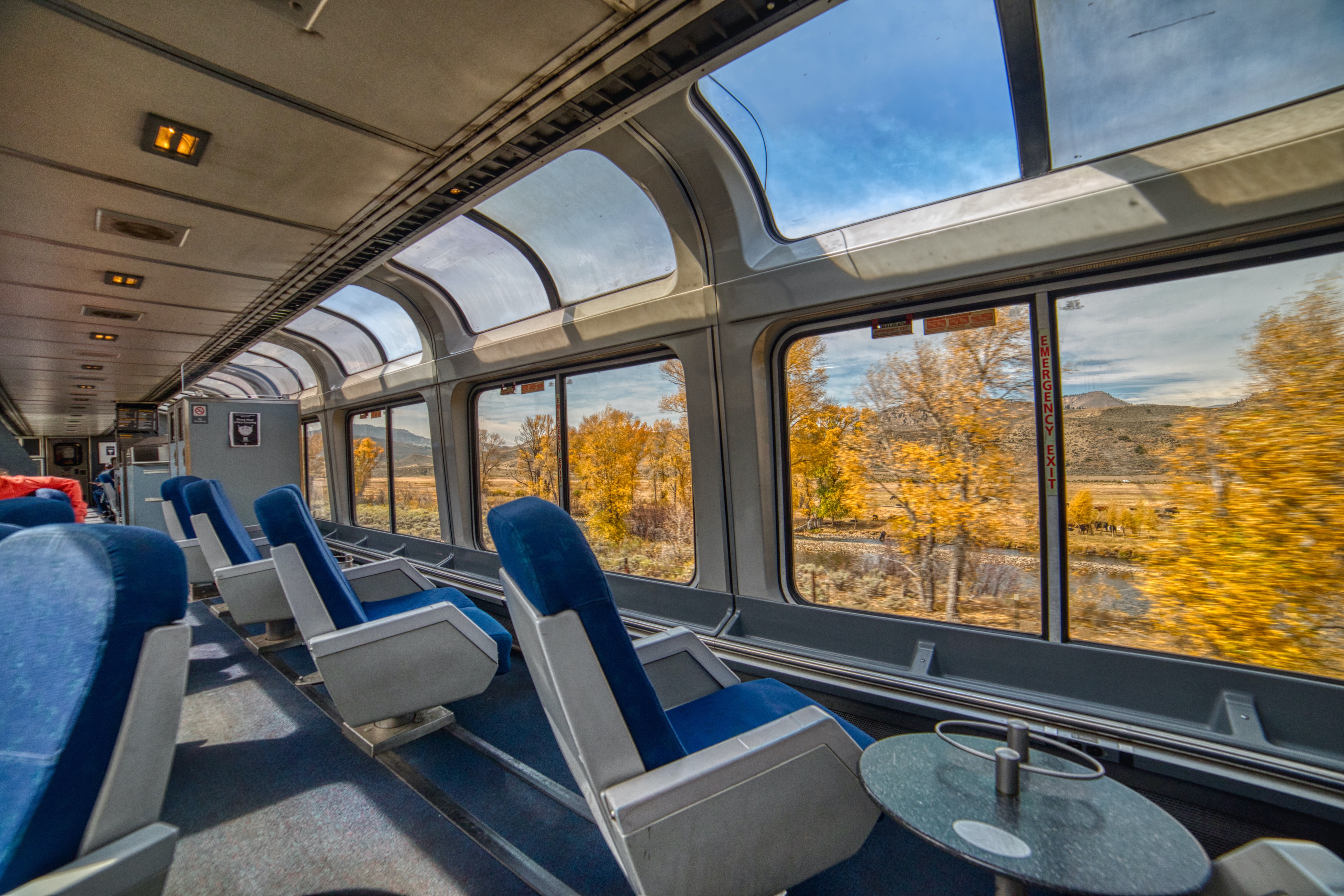 The observation car with windows looking out onto trees changing colors
