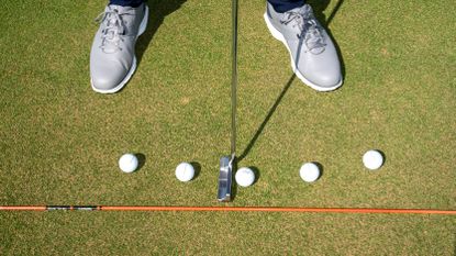 Five golf balls on the 18th green at Royal Troon