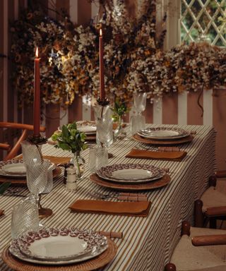 chrirstmas dining room with striped table linens and a rattan brown theme