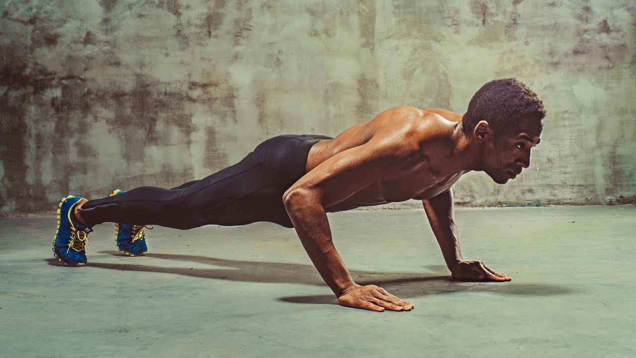 Athletic person doing push ups wearing workout shoes and tights