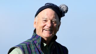 Actor Bill Murray smiles on the 17th green on Day Three of the Alfred Dunhill Links Championship wearing a tartan jacket and hat.
