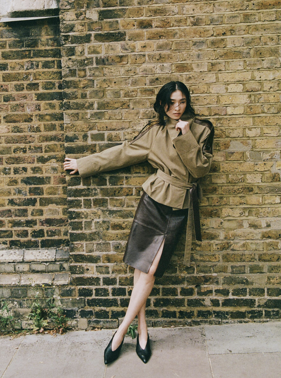 Massimo Dutti model wears leather skirt and trend coat