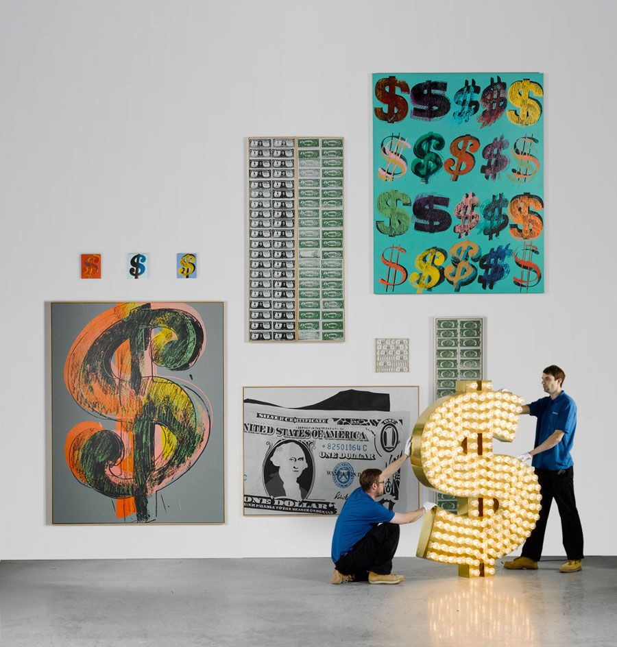 Various sized US dollar themed artworks on display at Sotheby&#039;s 