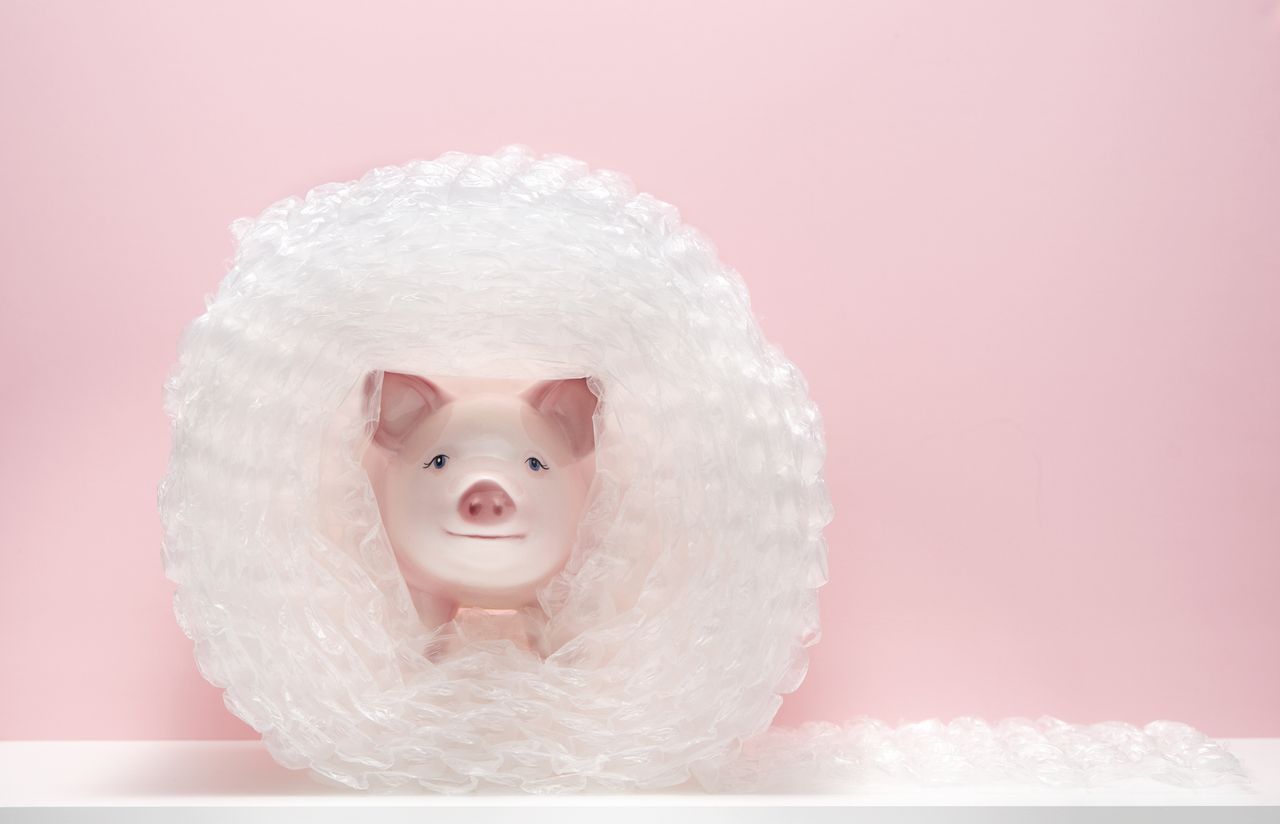 Preventing tax on savings symbolised by a piggy bank being wrapped in bubblewrap