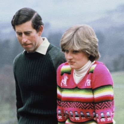 Prince Charles and Princess Diana wear sweaters and pose in the countryside