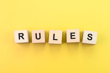 Rules text on wooden blocks.