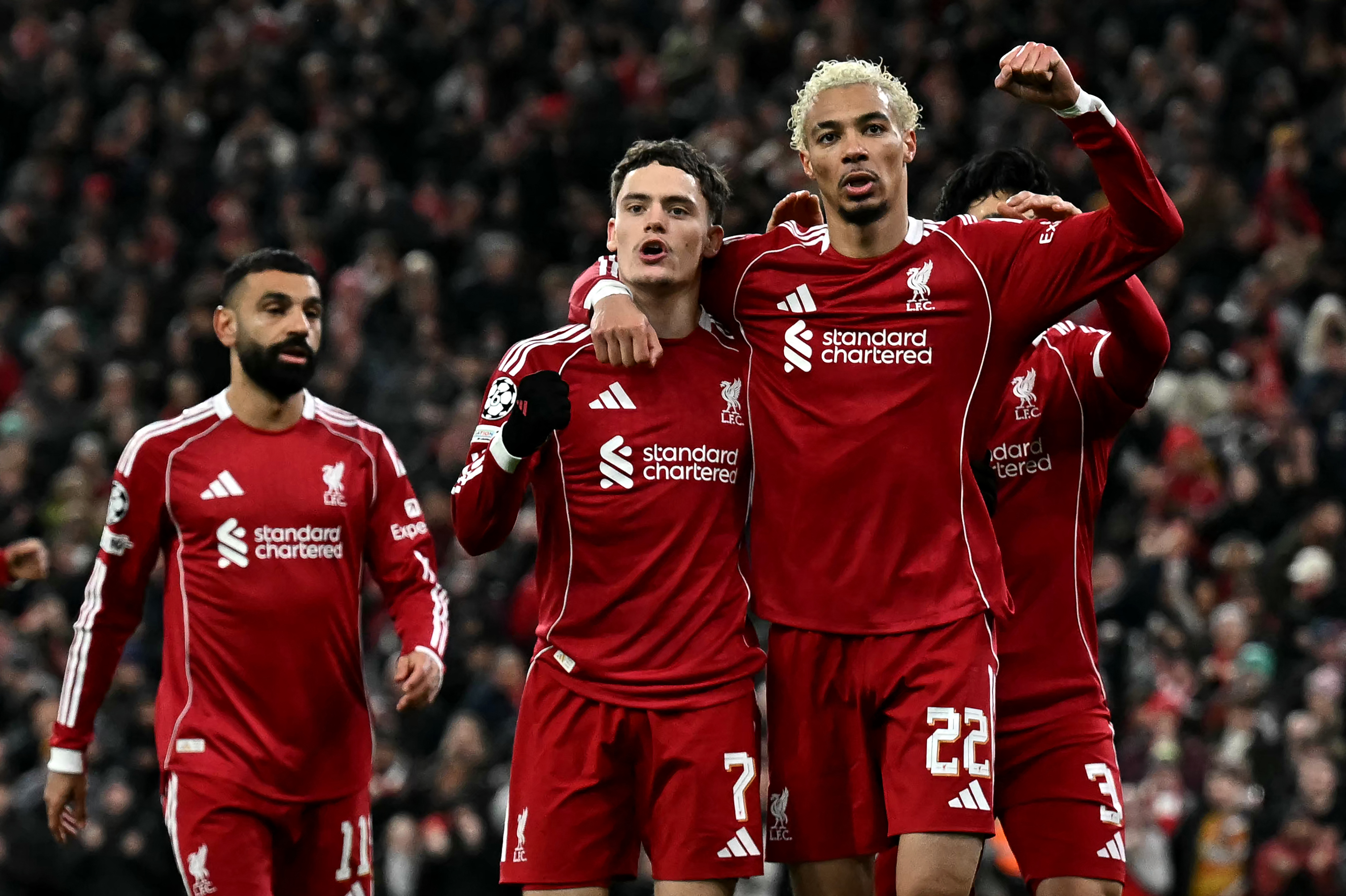 Liverpool's German midfielder #07 Florian Wirtz celebrates scoring the team's second goal with Liverpool's French striker #22 Hugo Ekitike (2R) during the UEFA Champions League football match between Liverpool and Qarabag at Anfield in Liverpool, north west England on January 28, 2026. (Photo by Paul ELLIS / AFP)