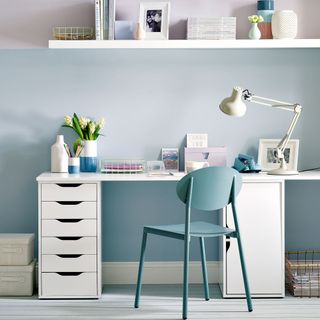 home office with white desk and blue chair