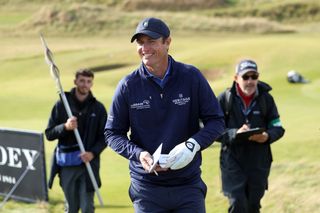 Nicolas Colsaerts smiles as he walks off the green following an albatross