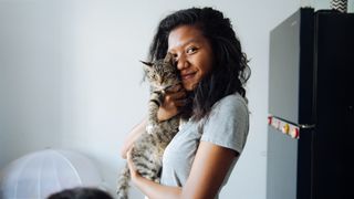 Woman cuddling her cat