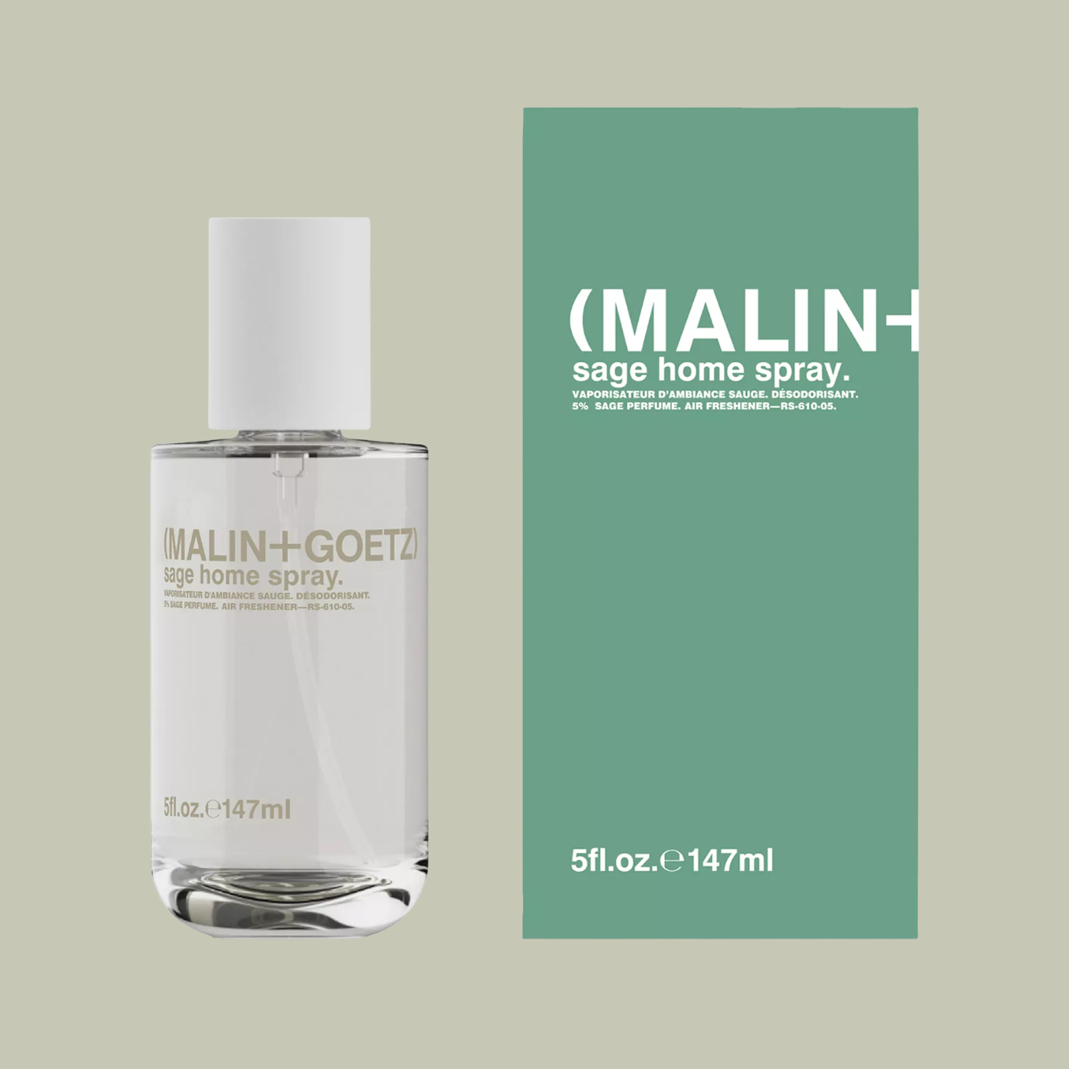 A glass bottle of rooms pray beside a green box for packaging