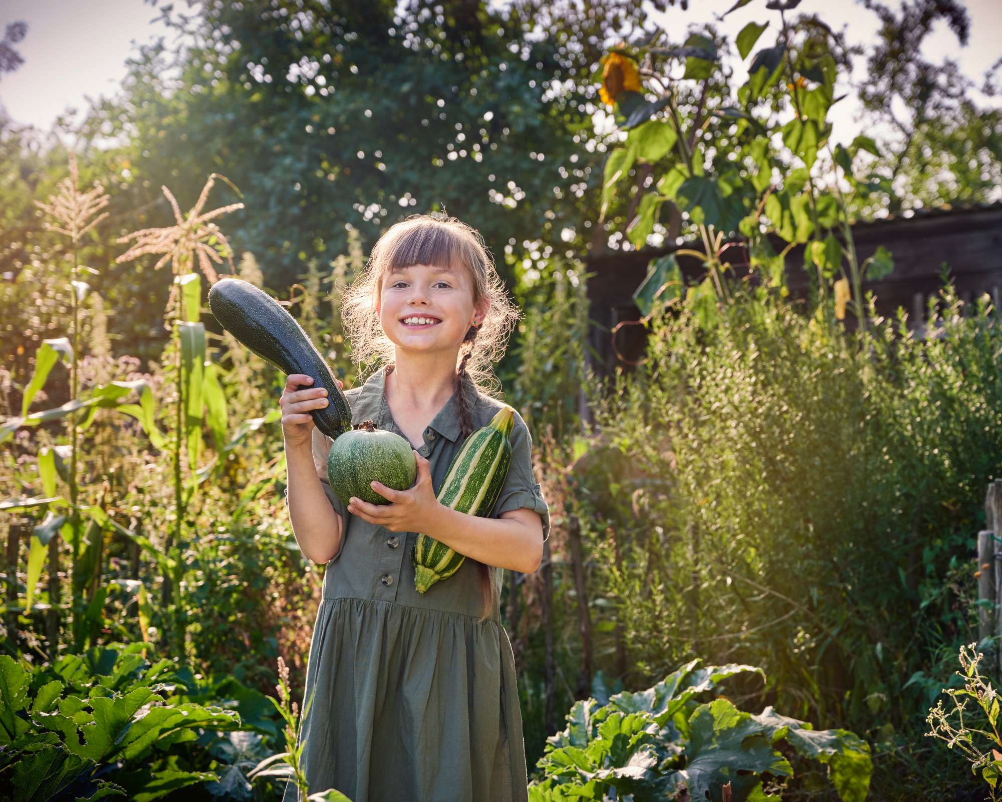 Smiling girl in vegetable garden