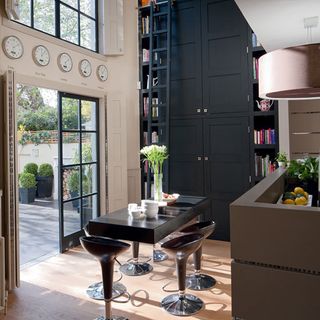 dining area with book shelves and french door