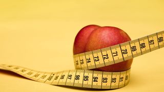 A measuring tape wrapped around a peach