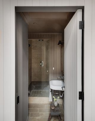 minimalist bathroom with brick flooring and shower cubicle
