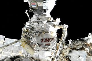 Russian cosmonauts Sergey Prokopyev (at bottom) and Dmitry Petelin work on a Strela boom outside of the Poisk mini-research module during a Nov. 17, 2022 spacewalk outside of the Russian segment of the International Space Station.