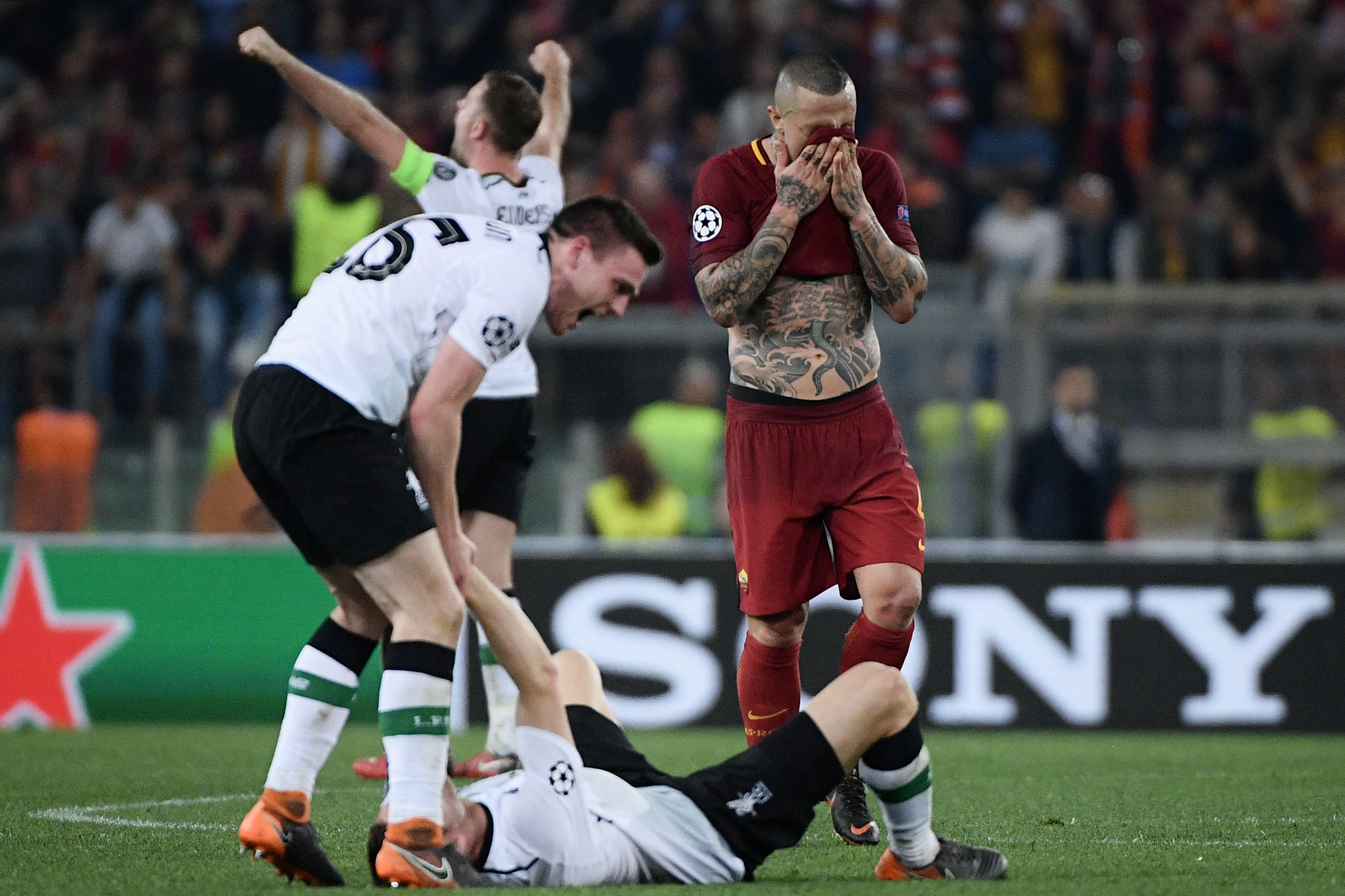 Roma's Belgian midfielder Radja Nainggolan reacts as Liverpool's players celebrate at the end of the UEFA Champions League semi-final second leg football match between AS Roma and Liverpool