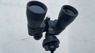 Wide view of the EclipSmart 12x50 binoculars on a tripod