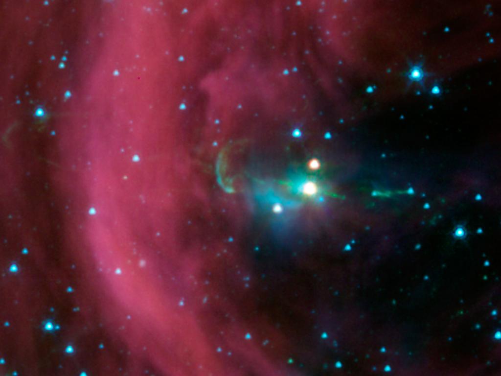 NASA&#039;s Spitzer Space Telescope took this image of a baby star sprouting two identical jets (green lines emanating from fuzzy star). The Spitzer image shows that both of the twin jets are made up of identical knots of gas and dust, ejected one after anothe