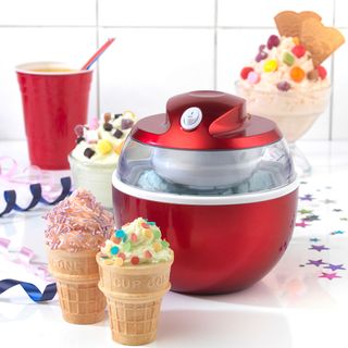 American Originals ice cream maker on a white kitchen counter surround by ice creams with various toppings
